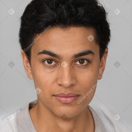 Joyful latino young-adult male with short  brown hair and brown eyes