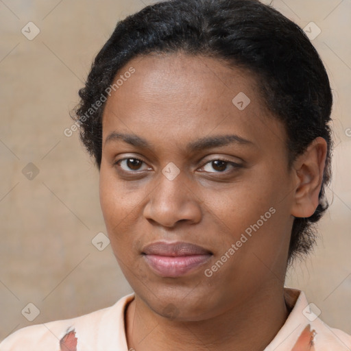 Joyful black young-adult female with short  brown hair and brown eyes