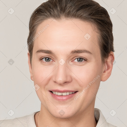 Joyful white young-adult female with short  brown hair and grey eyes