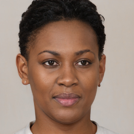 Joyful black young-adult female with short  brown hair and brown eyes
