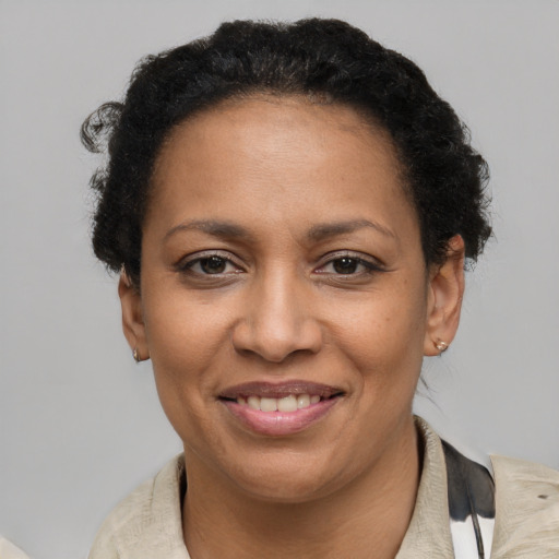 Joyful latino adult female with short  brown hair and brown eyes