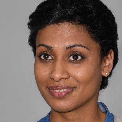 Joyful black young-adult female with short  brown hair and brown eyes