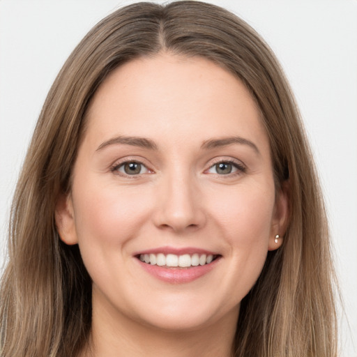 Joyful white young-adult female with long  brown hair and grey eyes