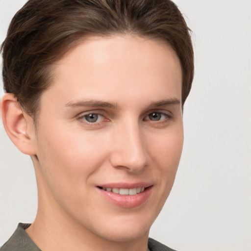 Joyful white young-adult female with short  brown hair and grey eyes