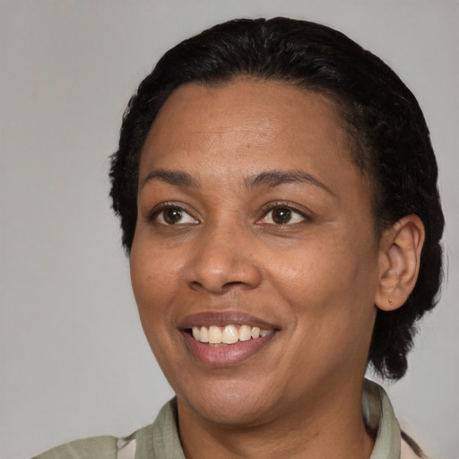 Joyful latino adult female with short  black hair and brown eyes