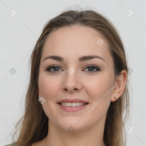 Joyful white young-adult female with long  brown hair and grey eyes