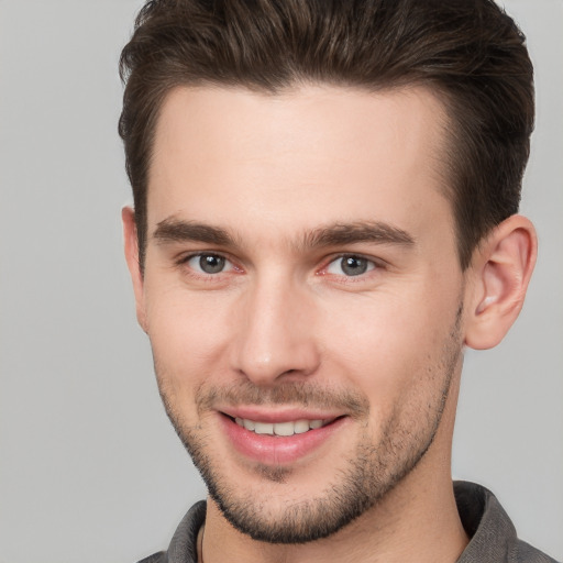 Joyful white young-adult male with short  brown hair and brown eyes