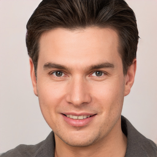 Joyful white young-adult male with short  brown hair and brown eyes