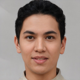 Joyful latino young-adult male with short  brown hair and brown eyes