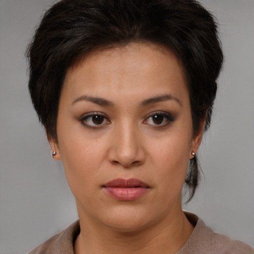 Joyful asian young-adult female with short  brown hair and brown eyes