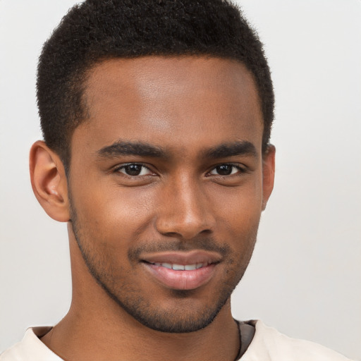 Joyful black young-adult male with short  brown hair and brown eyes