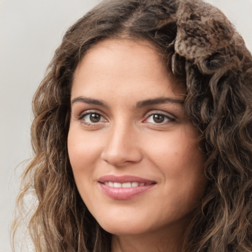 Joyful white young-adult female with long  brown hair and green eyes