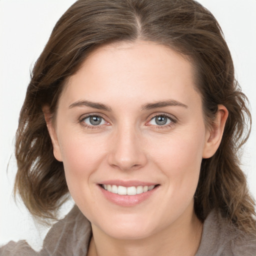 Joyful white young-adult female with medium  brown hair and grey eyes