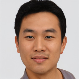 Joyful asian young-adult male with short  black hair and brown eyes