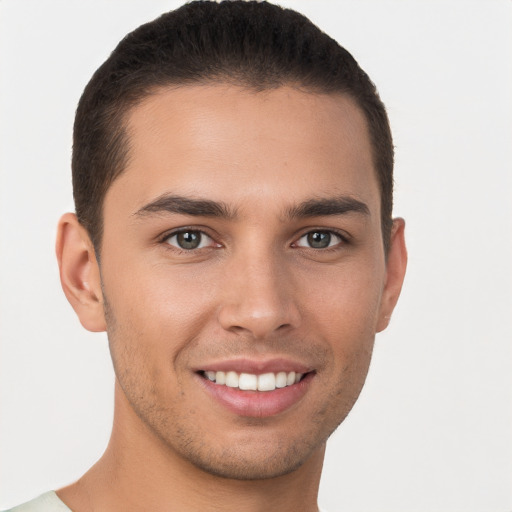 Joyful white young-adult male with short  brown hair and brown eyes