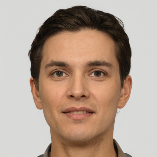 Joyful white young-adult male with short  brown hair and brown eyes