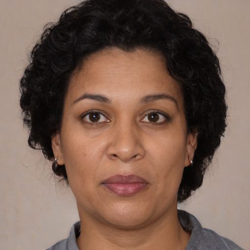 Joyful latino adult female with short  brown hair and brown eyes