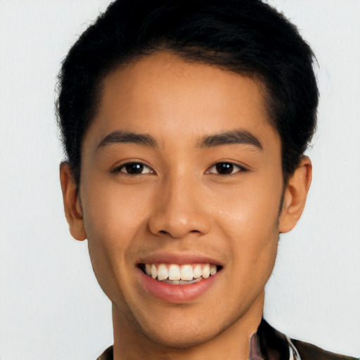 Joyful latino young-adult male with short  black hair and brown eyes