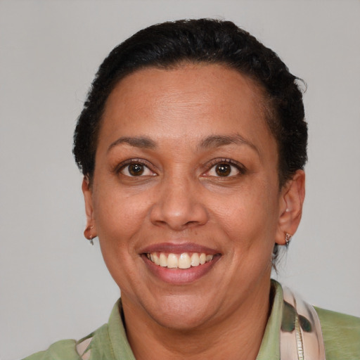 Joyful latino adult female with short  brown hair and brown eyes
