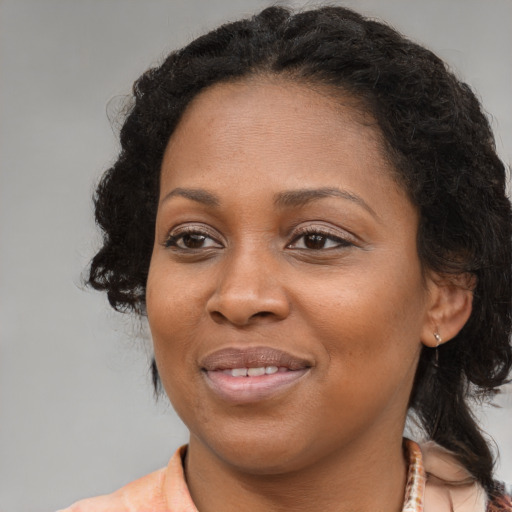 Joyful black young-adult female with medium  brown hair and brown eyes