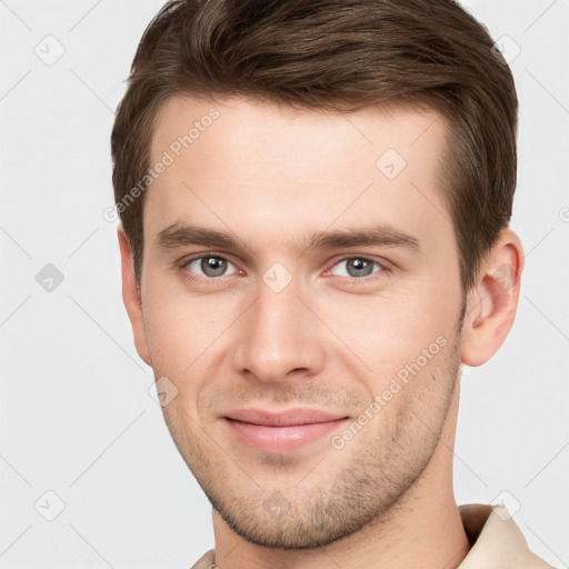 Joyful white young-adult male with short  brown hair and grey eyes