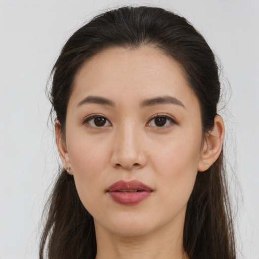 Joyful asian young-adult female with long  brown hair and brown eyes