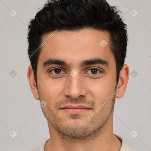 Joyful white young-adult male with short  black hair and brown eyes