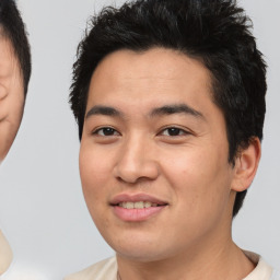 Joyful asian young-adult male with short  black hair and brown eyes