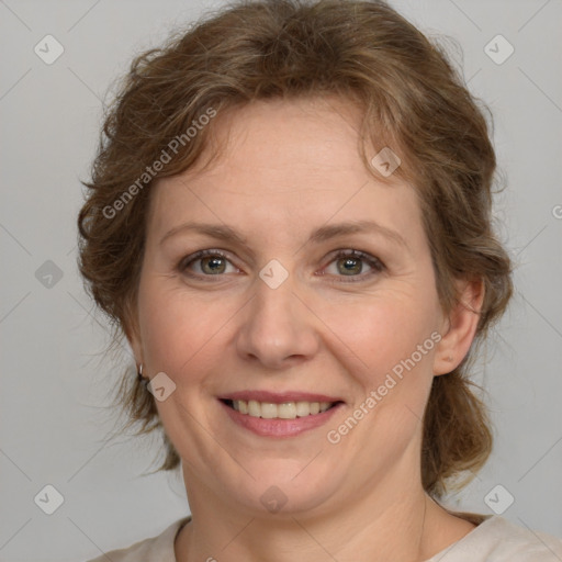 Joyful white adult female with medium  brown hair and green eyes