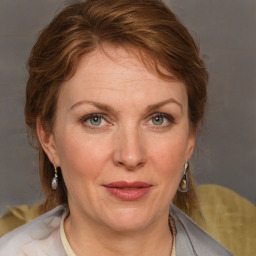 Joyful white adult female with medium  brown hair and blue eyes