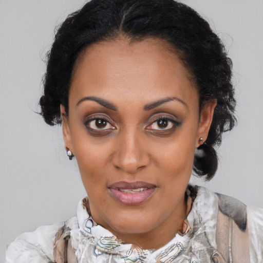 Joyful black adult female with medium  brown hair and brown eyes