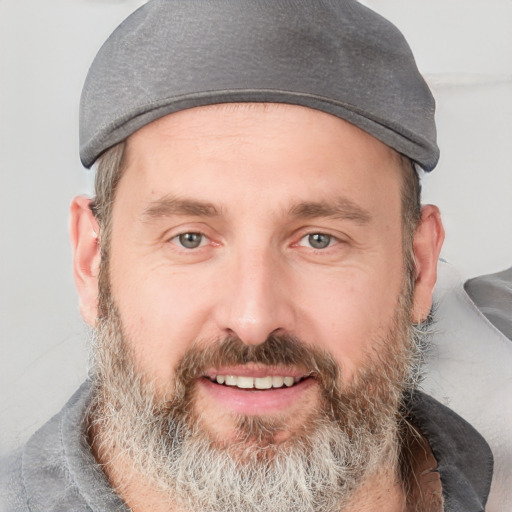 Joyful white adult male with short  brown hair and grey eyes