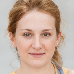 Joyful white young-adult female with medium  brown hair and blue eyes