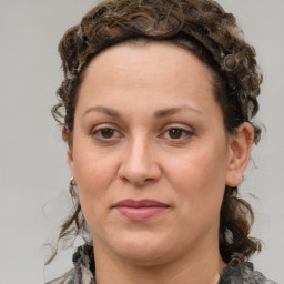 Joyful white adult female with medium  brown hair and green eyes