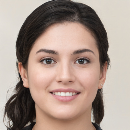 Joyful white young-adult female with medium  brown hair and brown eyes