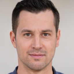 Joyful white adult male with short  brown hair and brown eyes