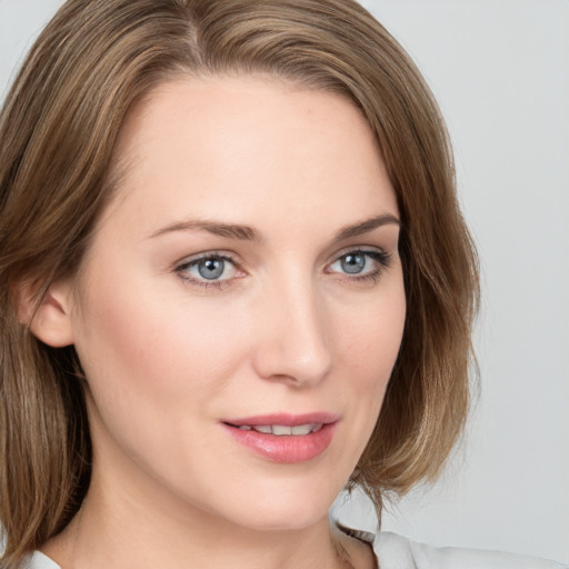 Joyful white young-adult female with medium  brown hair and blue eyes