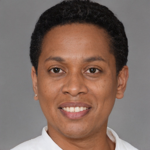 Joyful black adult female with short  black hair and brown eyes