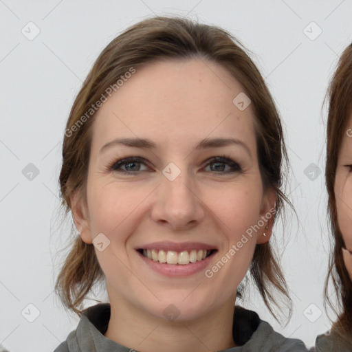 Joyful white young-adult female with medium  brown hair and grey eyes