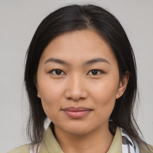 Joyful asian young-adult female with medium  brown hair and brown eyes