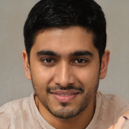 Joyful latino young-adult male with short  brown hair and brown eyes