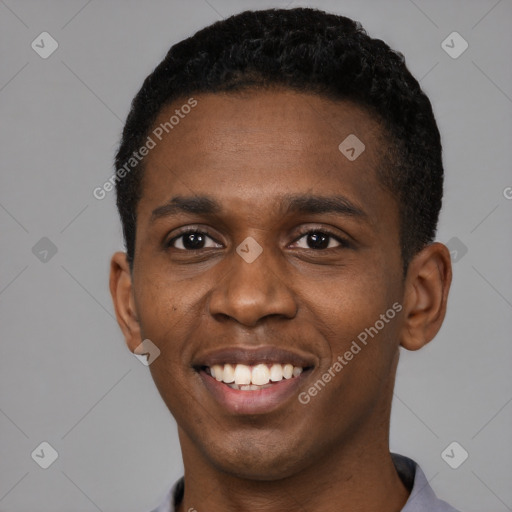 Joyful black young-adult male with short  black hair and brown eyes