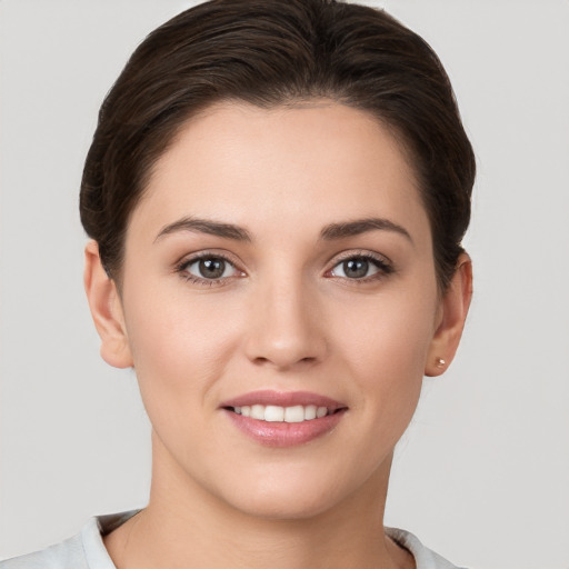 Joyful white young-adult female with short  brown hair and brown eyes