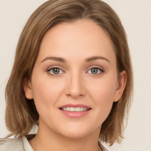 Joyful white young-adult female with medium  brown hair and green eyes