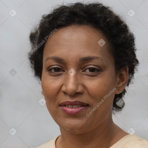 Joyful black adult female with short  brown hair and brown eyes