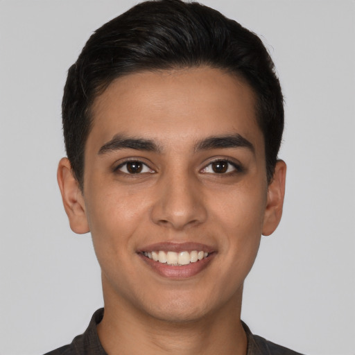 Joyful latino young-adult male with short  brown hair and brown eyes