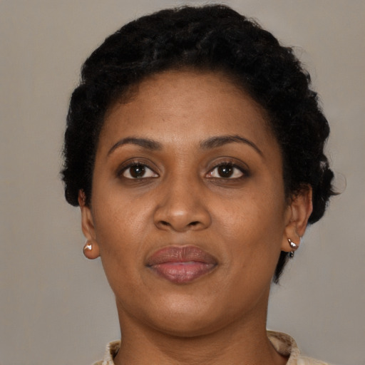 Joyful black adult female with short  brown hair and brown eyes