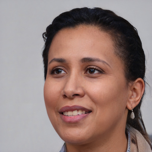 Joyful latino young-adult female with medium  black hair and brown eyes