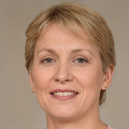 Joyful white adult female with medium  brown hair and grey eyes