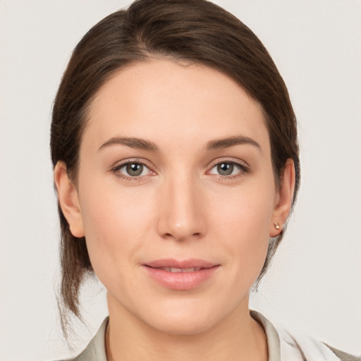 Joyful white young-adult female with medium  brown hair and grey eyes